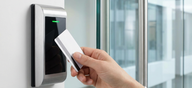 Eine Schlüsselkarte, die an eine Schließanlage gehalten wird